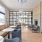 a clubroom with a large couch, tables and chairs