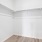 an empty closet with wood floors
