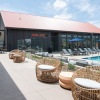 a pool with chairs all around it