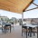 an outdoor grill area with tables and chairs