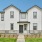 a white building with a grassy front lawn