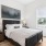 a bedroom with a bed and a chair