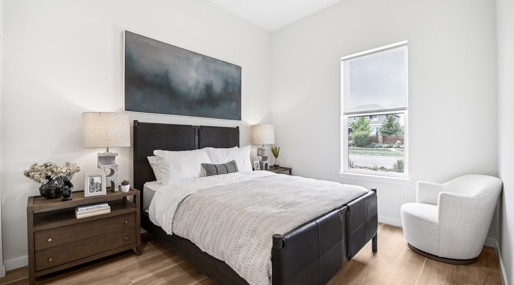 Beautiful bedrooms to fit every need a bedroom with a bed, two nightstands and a chair