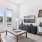 a living room with a couch, a coffee table and a tv