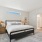 a bedroom with a bed and lamps