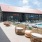 a building with a pool and chairs outside