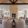 a clubroom with a fireplace, couches, chairs and tables