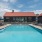 a swimming pool with lounge chairs