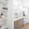 a bathroom with white walls and shelves